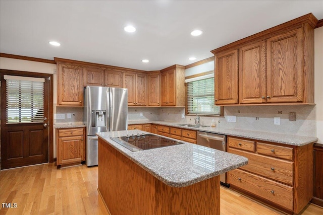 8133 Holly Forest Rd, Wake Forest, NC 27587 - kitchen with stainless steel appliances, a sink, ornamental molding, brown cabinetry, and recessed lighting