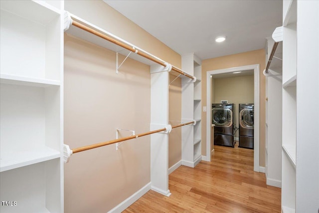8133 Holly Forest Rd, Wake Forest, NC 27587 - spacious closet with washer and clothes dryer and light wood finished floors