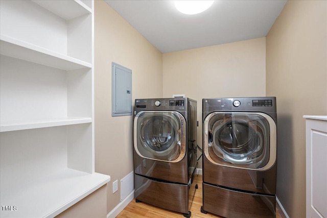 8133 Holly Forest Rd, Wake Forest, NC 27587 - washroom with electric panel, washing machine and dryer, wood finished floors, and baseboards