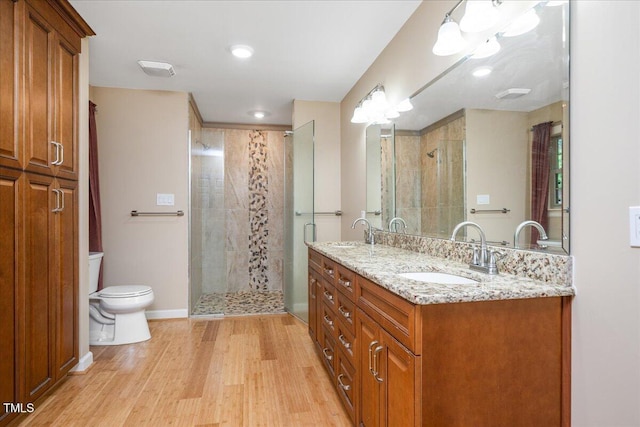 8133 Holly Forest Rd, Wake Forest, NC 27587 - full bath featuring toilet, a shower stall, double vanity, wood finished floors, and recessed lighting