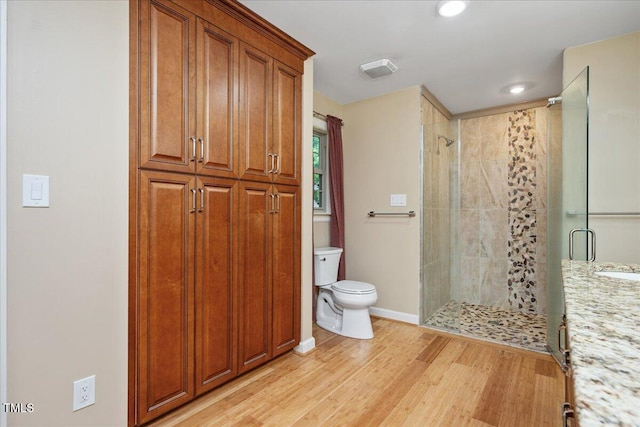 8133 Holly Forest Rd, Wake Forest, NC 27587 - full bath with a stall shower, toilet, wood finished floors, baseboards, and recessed lighting