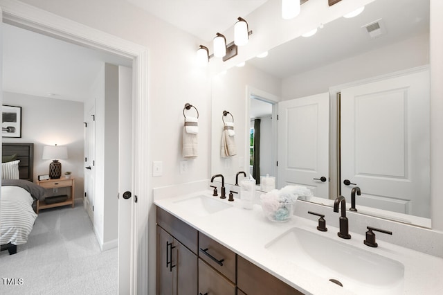 ensuite bathroom with double vanity and baseboards