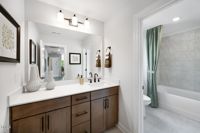 bathroom featuring toilet, vanity, shower / tub combo with curtain, baseboards, and tile patterned floors