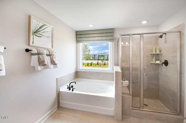 bathroom with a shower stall, a bath, recessed lighting, and baseboards