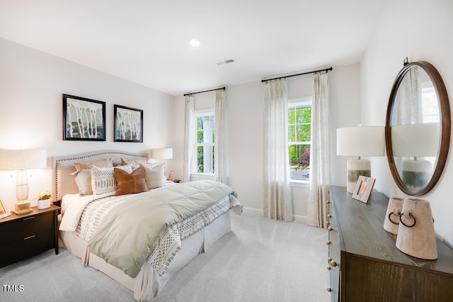 bedroom with light carpet and baseboards