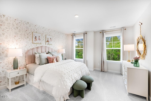 bedroom featuring baseboards, multiple windows, wallpapered walls, and light colored carpet