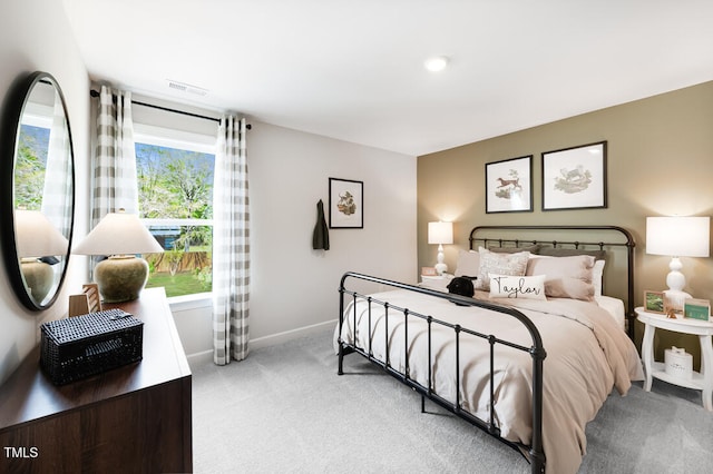 bedroom featuring light carpet and baseboards