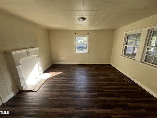 spare room with dark wood-style floors and baseboards