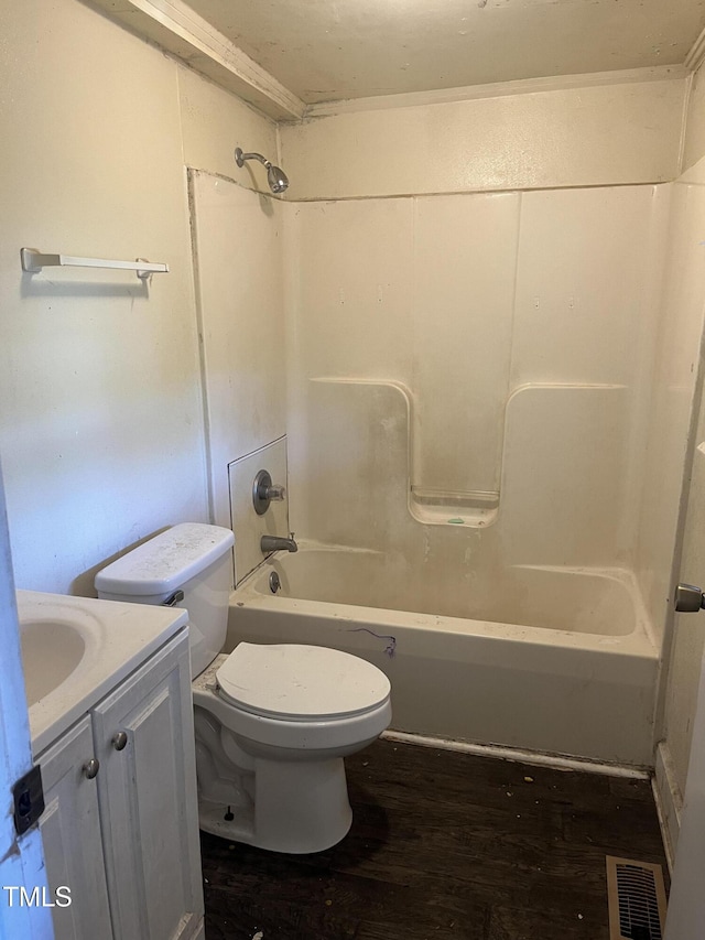 full bathroom featuring toilet, wood finished floors, washtub / shower combination, and vanity