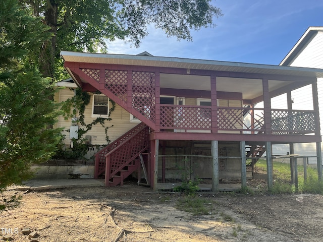 rear view of property featuring stairs