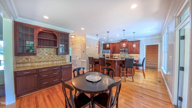 8042 Hogan Dr, Wake Forest, NC 27587 - dining space featuring ornamental molding, light wood-style flooring, recessed lighting, and baseboards