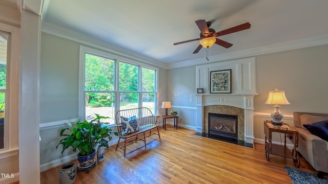 8042 Hogan Dr, Wake Forest, NC 27587 - sitting room with a fireplace with flush hearth, wood finished floors, ceiling fan, ornamental molding, and baseboards