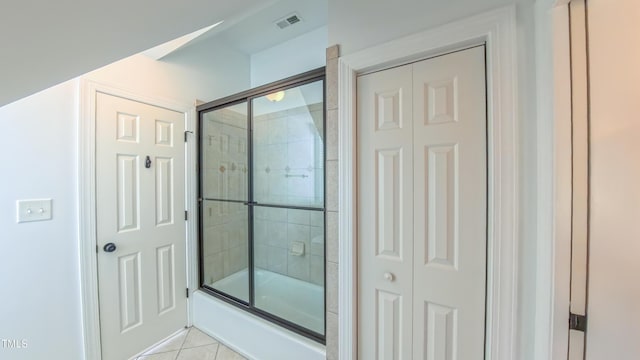 8042 Hogan Dr, Wake Forest, NC 27587 - full bathroom with tile patterned flooring, combined bath / shower with glass door, and a closet