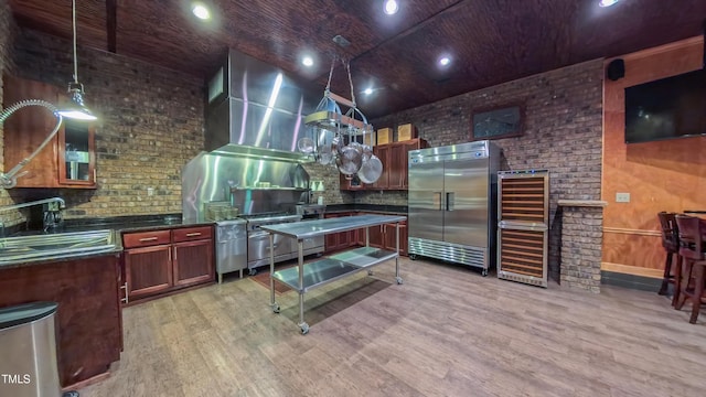 3197 Carriage Creek Ct, Haw River, NC 27258 - kitchen featuring stainless steel built in refrigerator, light wood-type flooring, dark countertops, pendant lighting, and a sink