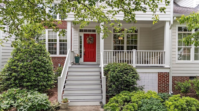 3923 Napa Valley Dr, Raleigh, NC 27612 - doorway to property featuring a shingled roof and covered porch