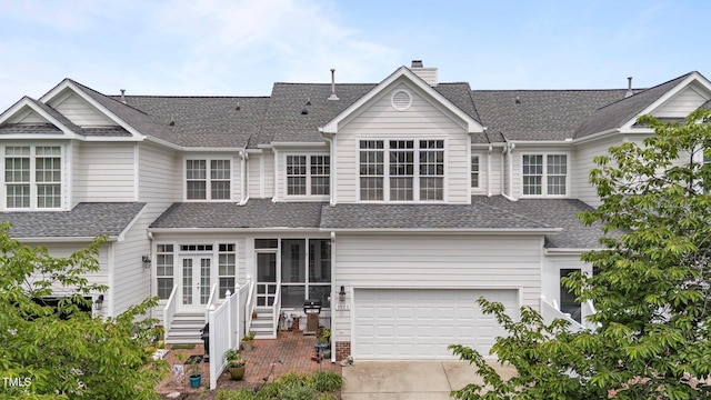3923 Napa Valley Dr, Raleigh, NC 27612 - view of front of house featuring driveway, an attached garage, a sunroom, and a shingled roof