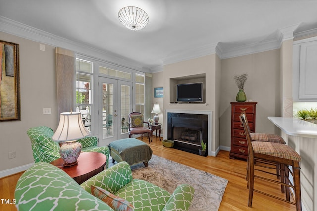 3923 Napa Valley Dr, Raleigh, NC 27612 - living room featuring french doors, crown molding, light wood-style floors, a fireplace, and baseboards