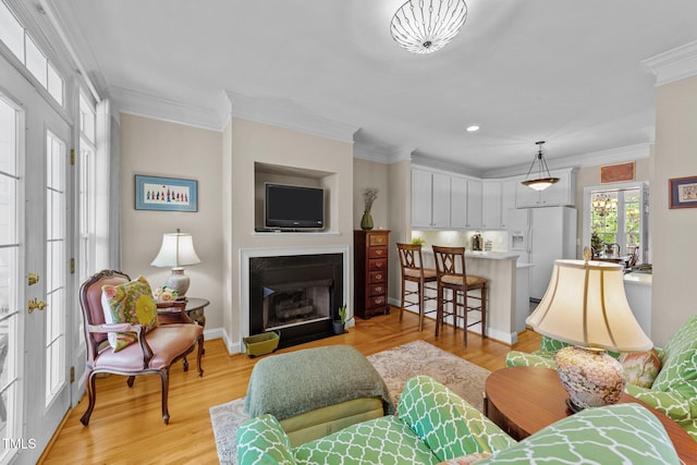 3923 Napa Valley Dr, Raleigh, NC 27612 - living area featuring crown molding, a fireplace with flush hearth, light wood finished floors, recessed lighting, and baseboards