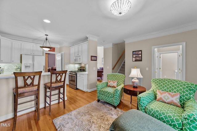 3923 Napa Valley Dr, Raleigh, NC 27612 - living area with ornamental molding, stairway, and light wood-style floors