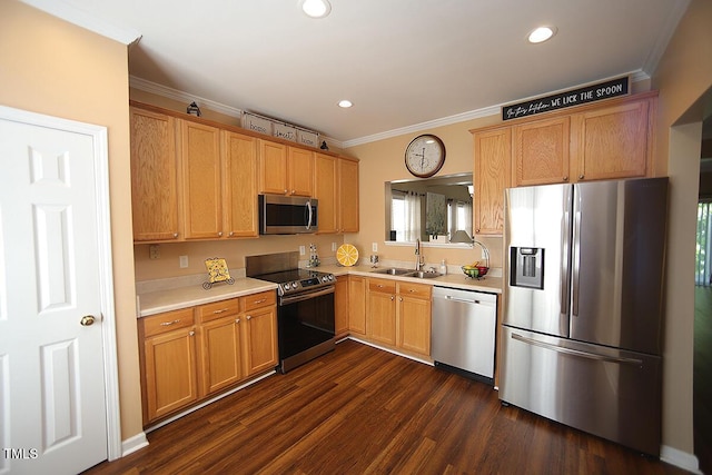 kitchen with appliances with stainless steel finishes, a sink, light countertops, crown molding, and dark wood-style flooring