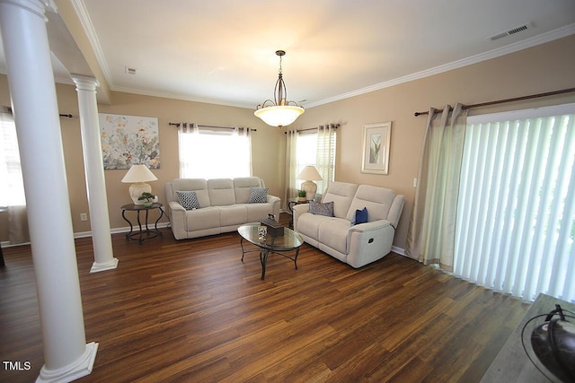 living area featuring decorative columns, dark wood-type flooring, crown molding, and baseboards