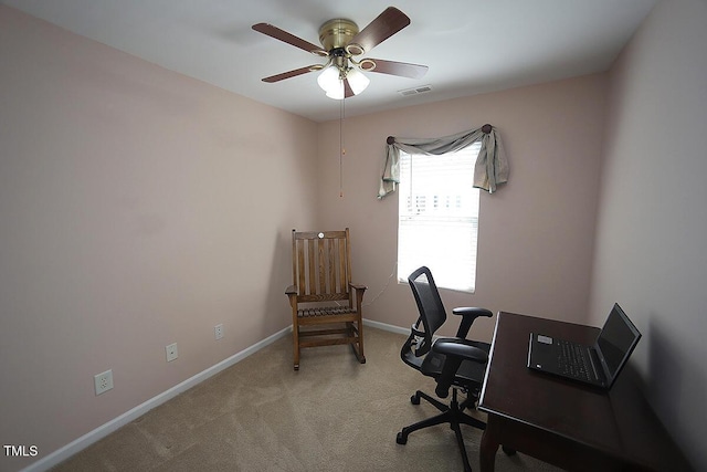office area featuring light colored carpet, a ceiling fan, and baseboards