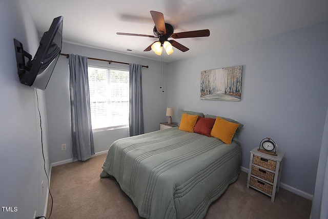 carpeted bedroom featuring baseboards and a ceiling fan