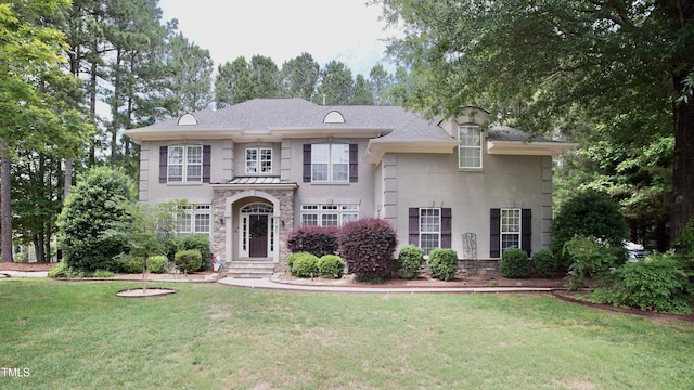 17832 Durrango Ct, Charlotte, NC 28278 - view of front facade with stucco siding, a front yard, and stone siding