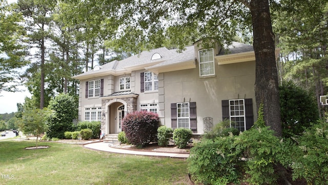 17832 Durrango Ct, Charlotte, NC 28278 - view of front of home featuring stucco siding, a front yard, and stone siding
