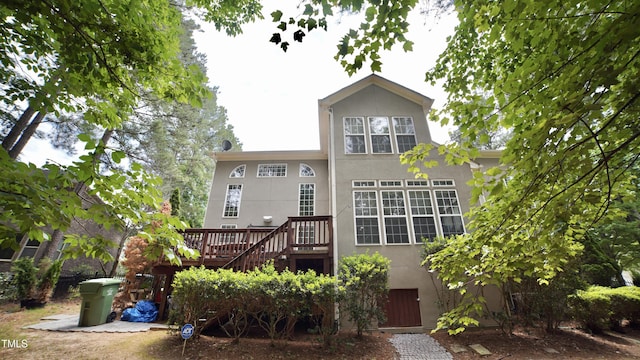 17832 Durrango Ct, Charlotte, NC 28278 - back of house featuring stucco siding, a wooden deck, and stairs