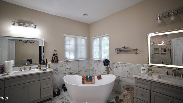 17832 Durrango Ct, Charlotte, NC 28278 - full bath featuring tile walls, marble tiled floors, two vanities, a freestanding tub, and a stall shower
