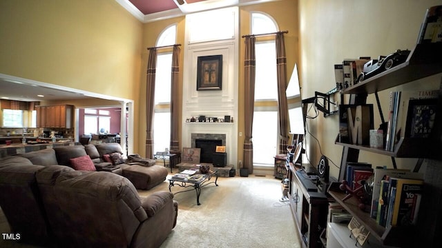 17832 Durrango Ct, Charlotte, NC 28278 - living room featuring a high ceiling, crown molding, carpet, and a stone fireplace