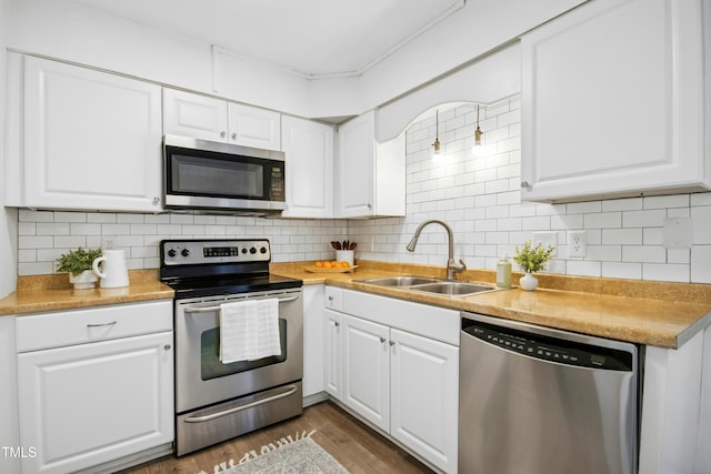 1208 Manassas Ct Unit A, Raleigh, NC 27609 - kitchen featuring appliances with stainless steel finishes, a sink, white cabinets, and light countertops