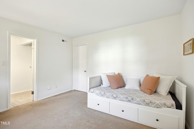 1208 Manassas Ct Unit A, Raleigh, NC 27609 - carpeted bedroom with baseboards and connected bathroom