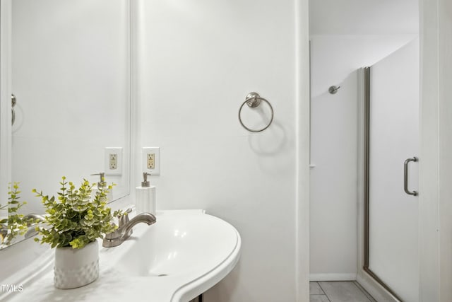 1208 Manassas Ct Unit A, Raleigh, NC 27609 - bathroom featuring a shower stall, tile patterned flooring, and a sink