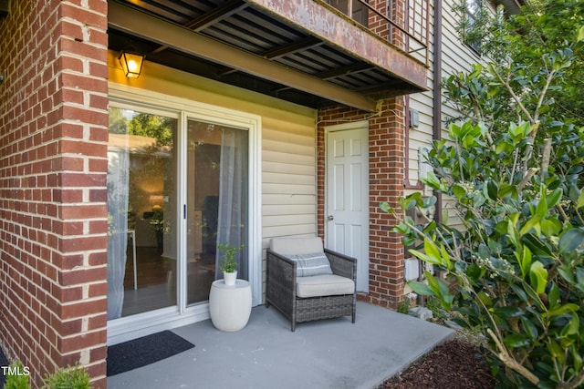 1208 Manassas Ct Unit A, Raleigh, NC 27609 - view of exterior entry featuring brick siding and a balcony