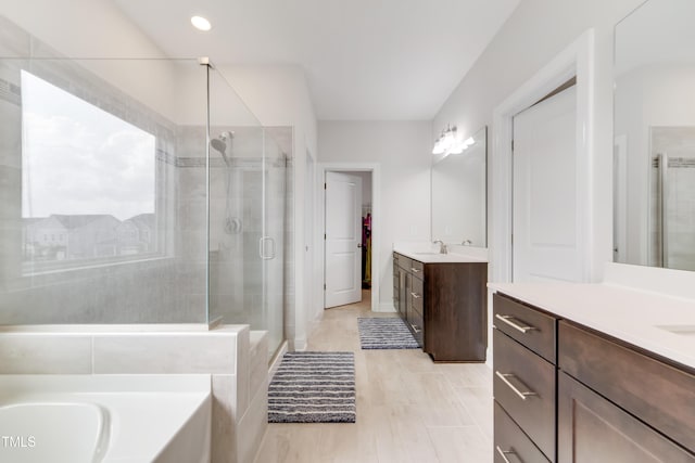 5420 Mill Dam Rd, Wake Forest, NC 27587 - full bathroom with a stall shower, two vanities, a tub, and a spacious closet