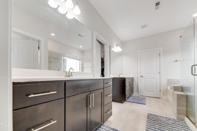 5420 Mill Dam Rd, Wake Forest, NC 27587 - bathroom with a stall shower, two vanities, a bath, and baseboards