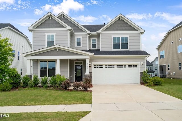 5420 Mill Dam Rd, Wake Forest, NC 27587 - craftsman house featuring a front lawn, a garage, concrete driveway, a porch, and stone siding