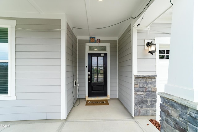 5420 Mill Dam Rd, Wake Forest, NC 27587 - view of exterior entry with stone siding and a porch