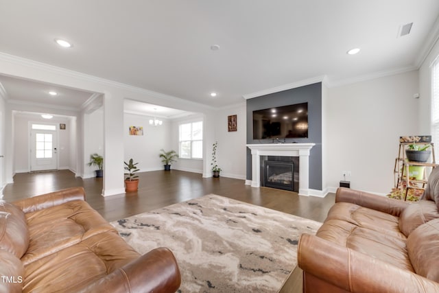 5420 Mill Dam Rd, Wake Forest, NC 27587 - living area with healthy amount of natural light, wood finished floors, a glass covered fireplace, crown molding, and recessed lighting