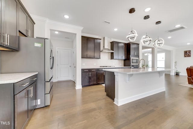5420 Mill Dam Rd, Wake Forest, NC 27587 - kitchen featuring stainless steel appliances, wall chimney exhaust hood, ornamental molding, a breakfast bar area, and decorative backsplash