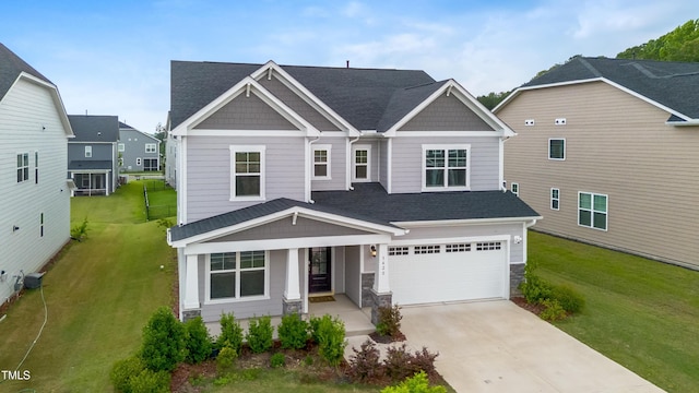 5420 Mill Dam Rd, Wake Forest, NC 27587 - craftsman house featuring a porch, driveway, a front yard, roof with shingles, and a garage