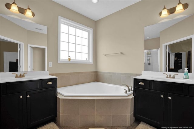 213 Windwood Dr, Stedman, NC 28391 - bathroom featuring a shower stall, a garden tub, two vanities, and tile patterned floors