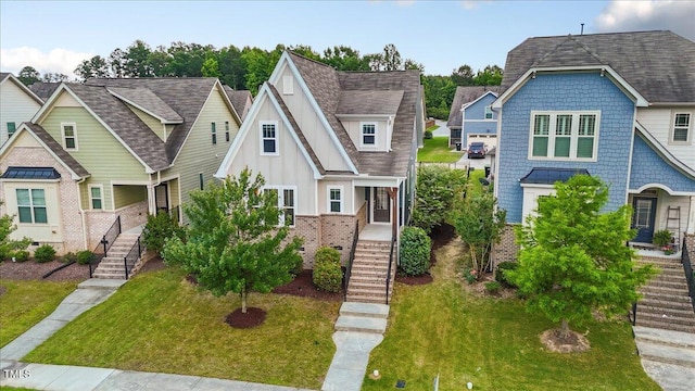 2837 Milano Ave, Apex, NC 27502 - view of front of house featuring stairs, board and batten siding, a front yard, and roof with shingles