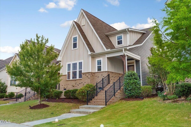 2837 Milano Ave, Apex, NC 27502 - view of front of house with stairs, board and batten siding, a front yard, and brick siding