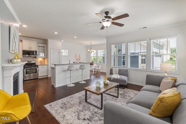 2837 Milano Ave, Apex, NC 27502 - living area with ornamental molding, ceiling fan, a chandelier, baseboards, and dark wood finished floors