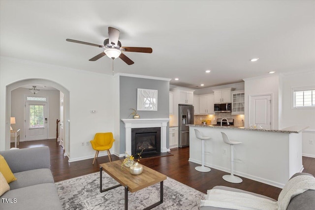 2837 Milano Ave, Apex, NC 27502 - living area with healthy amount of natural light, arched walkways, ceiling fan, dark wood-style flooring, and recessed lighting