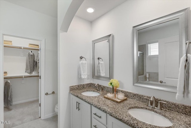 2837 Milano Ave, Apex, NC 27502 - full bath with double vanity, toilet, a spacious closet, and tile patterned floors