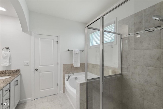 2837 Milano Ave, Apex, NC 27502 - bathroom with a garden tub, vanity, a stall shower, tile patterned flooring, and baseboards